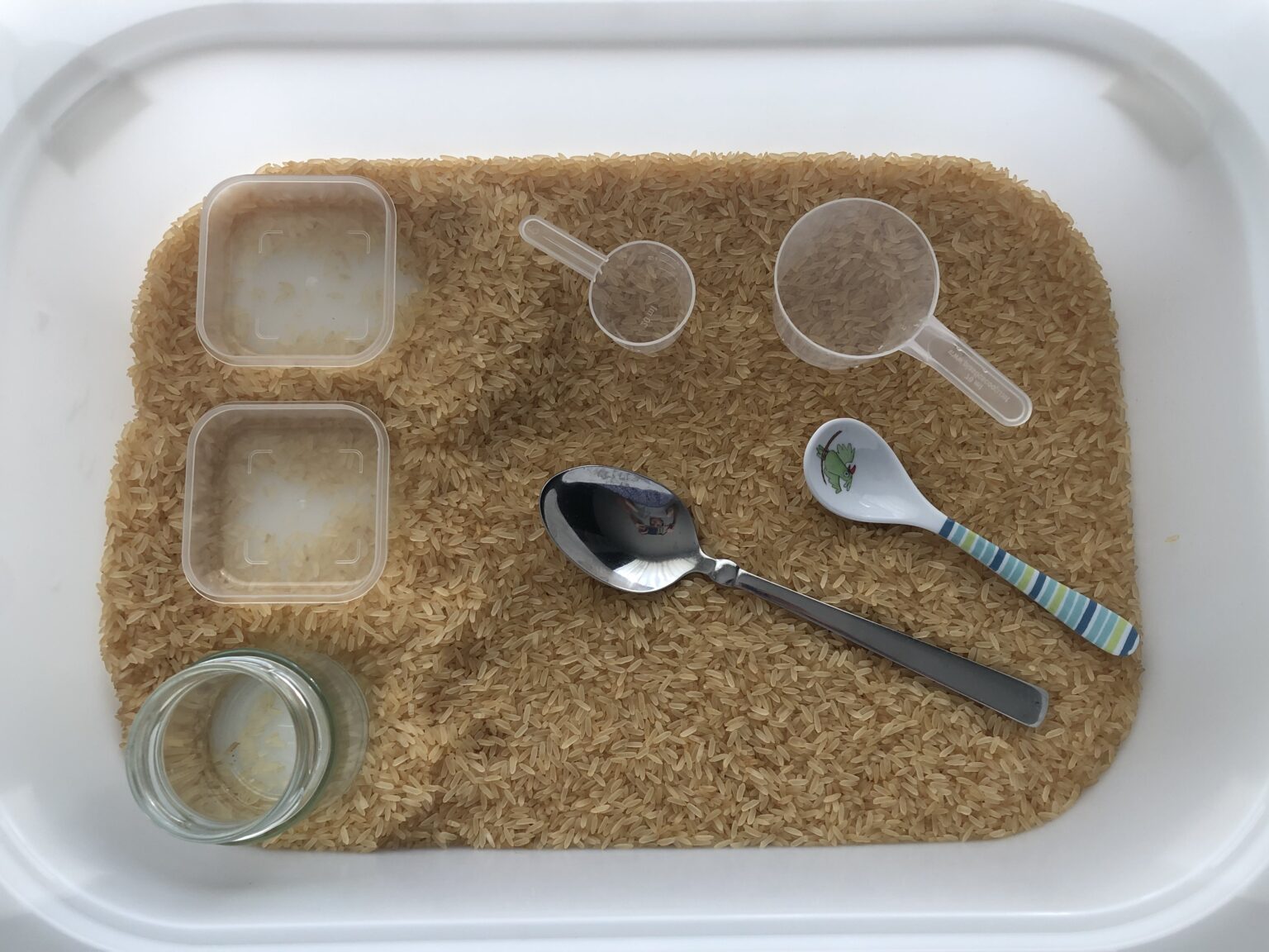 Rice sensory bin Happy Mommy Pose